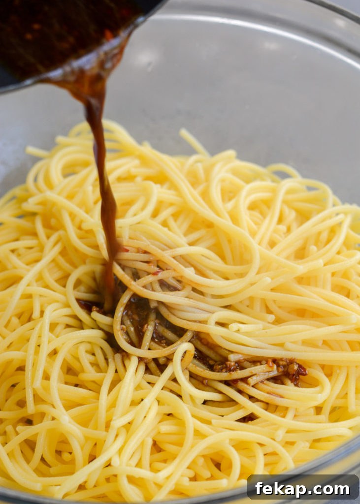 Gluten Free Sesame Noodles Recipe with Creamy Tahini Sauce 4 Sesame noodles being tossed in sauce