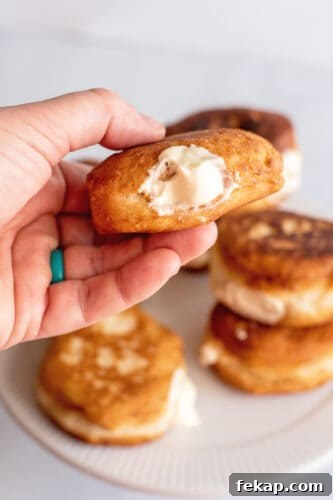 Mini Boston Cream Pies, Southern-Style 9 Hand showing filled mini Boston cream pie