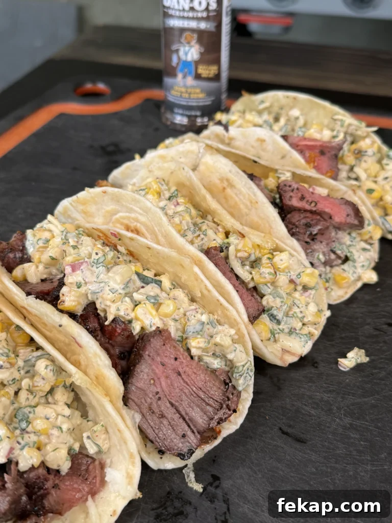 Grilled Steak Tacos with Elote Style Corn Recipe 2 elote steak tacos on a cutting board