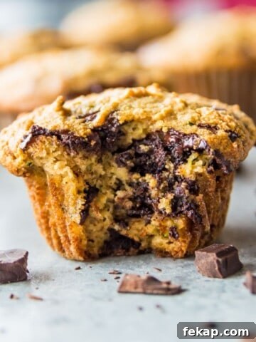 Banana Protein Muffins: 12g Protein Per Muffin 8 A paleo chocolate chip zucchini muffin with a bite out of it.