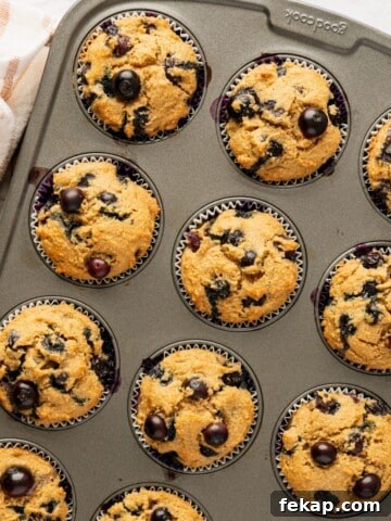 Banana Protein Muffins: 12g Protein Per Muffin 9 A muffin pan filled with a batch of baked blueberry muffins.
