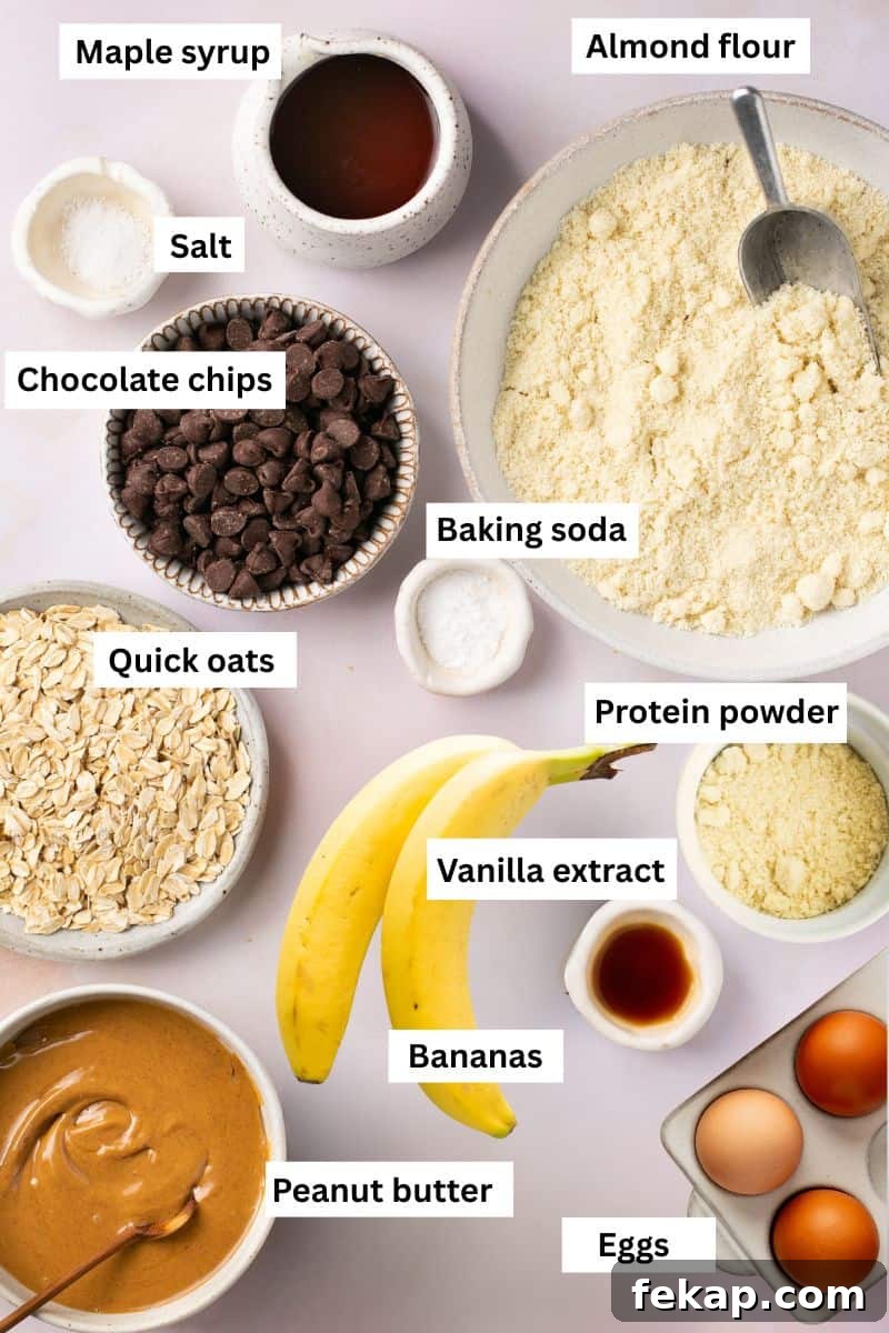 Banana Protein Muffins: 12g Protein Per Muffin 2 The ingredients for making banana protein muffins separated in bowls including flour, oats, bananas, eggs, chocolate chips, protein powder and peanut butter.
