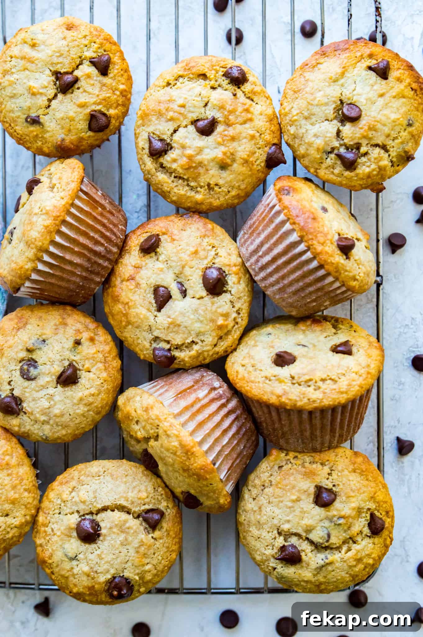 Banana Protein Muffins: 12g Protein Per Muffin 5 A batch of banana chocolate chip muffins on a baking rack.