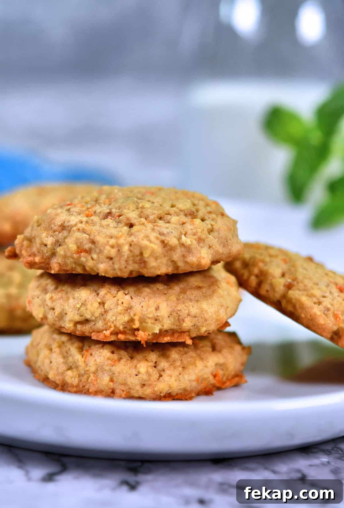 oatmeal carrot cookies stacked on white plate.