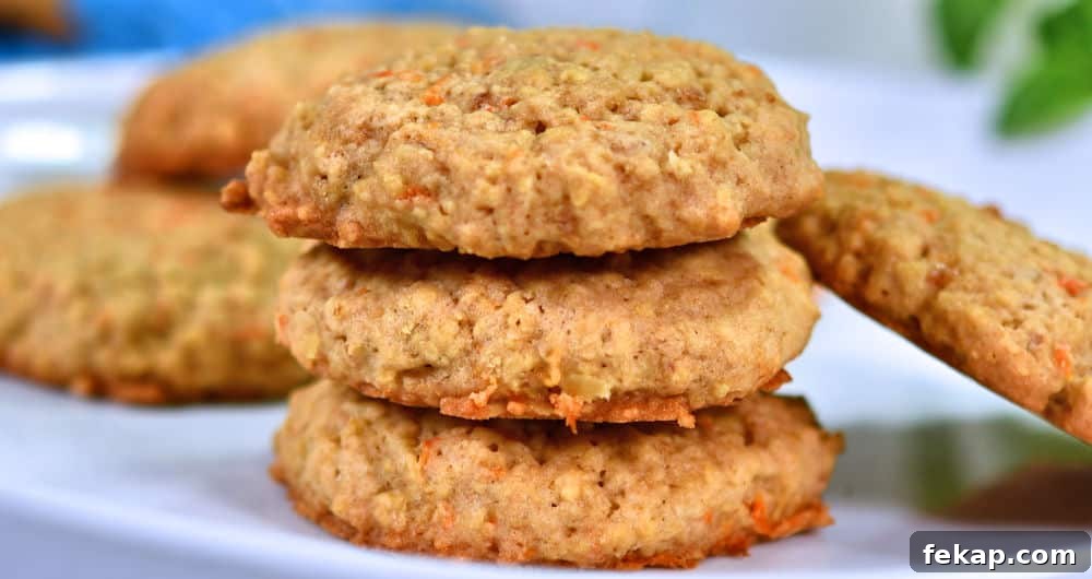 oatmeal carrot cookies stacked on white plate.