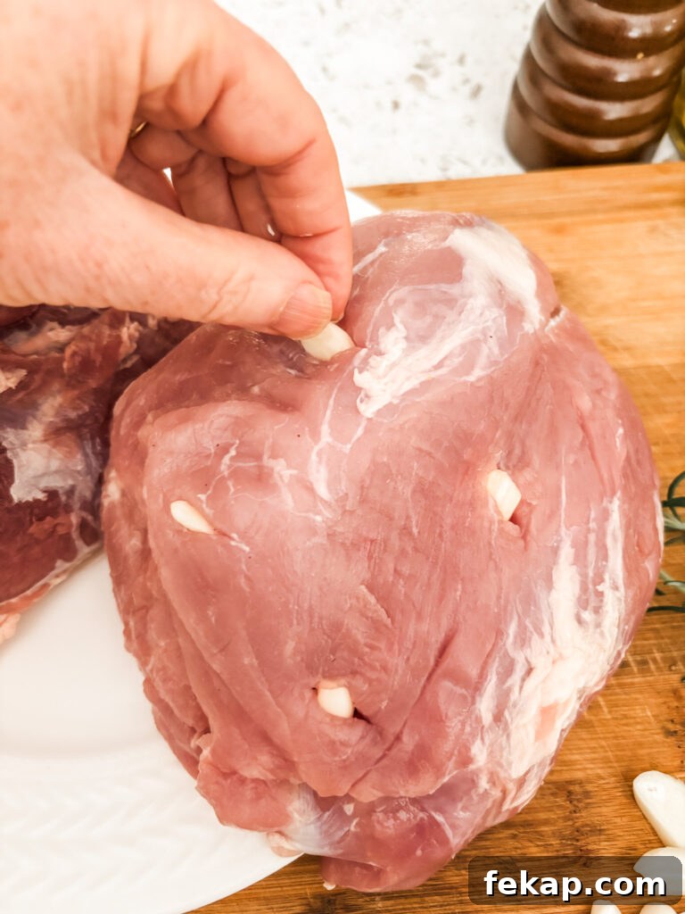 Herb-Rubbed Pork Sirloin Roast Recipe 5 Marie demonstrating how the pockets of silvered garlic should look