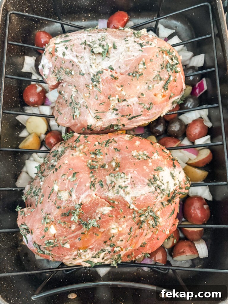 Herb-Rubbed Pork Sirloin Roast Recipe 6 The herb rubbed pork on a roasting rack with the vegetables underneath