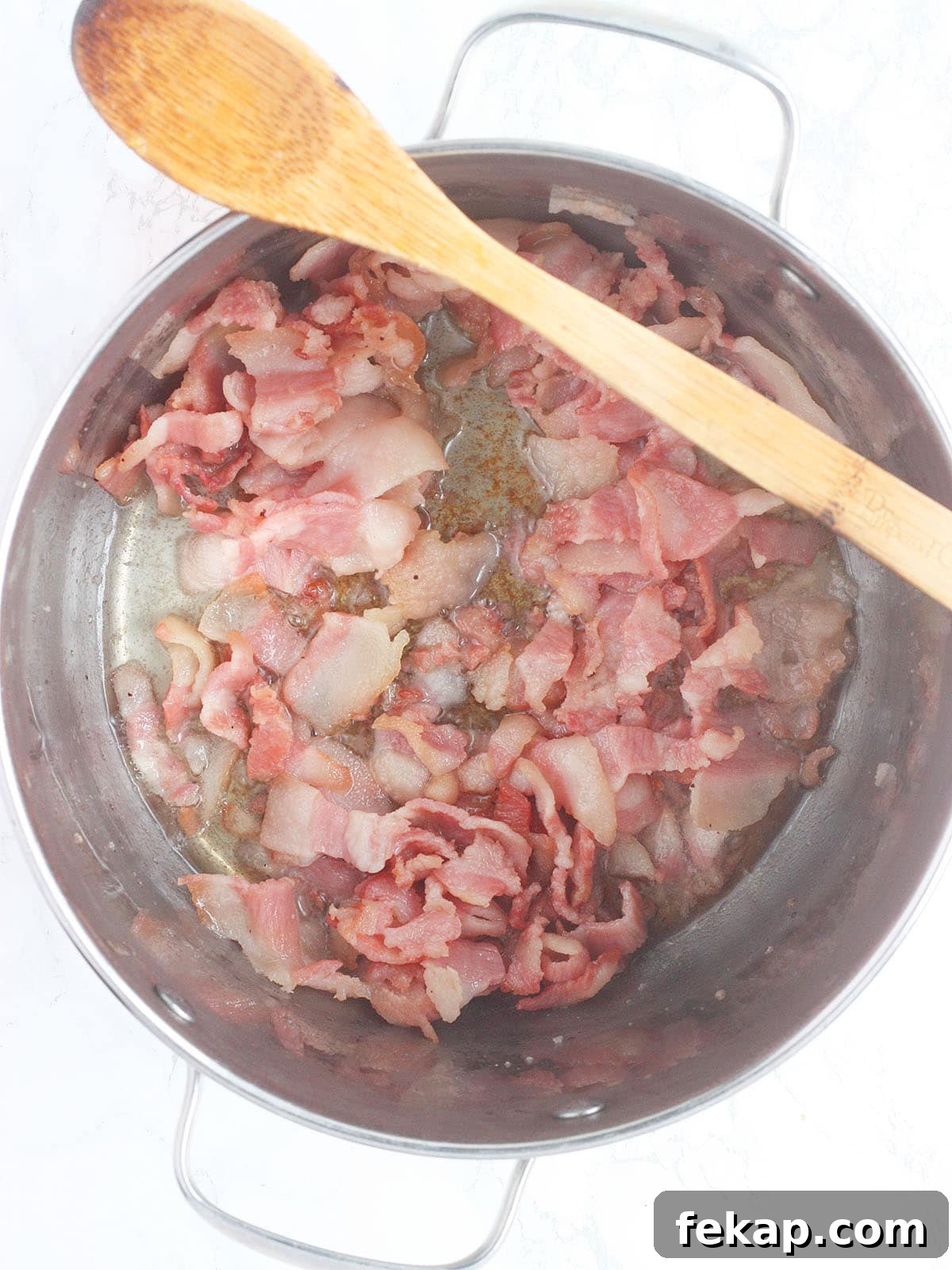 How to Make Southern Turnip Greens 8 salt pork sautéing in a stainless steel pot