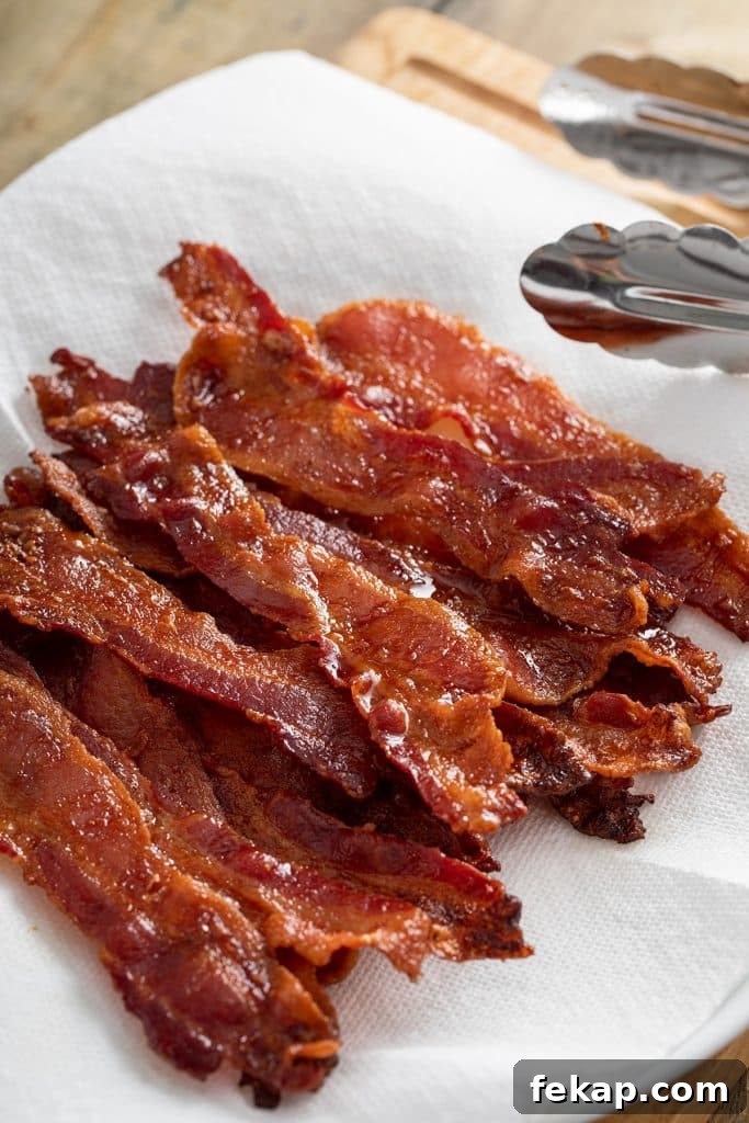 Crispy Oven-Baked Bacon: Perfectly Roasted Every Time 2 Crisp golden brown bacon strips draining on paper towels