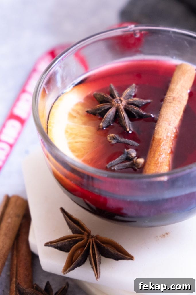 A pot of German Glühwein with orange slices and spices