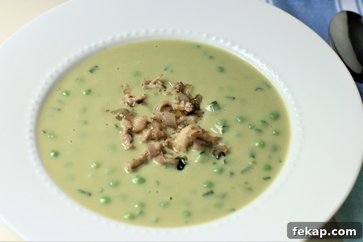 How to Identify and Cook Coral Mushrooms 15 hericium mushroom garnish on a bowl of creamed pea and lettuce soup