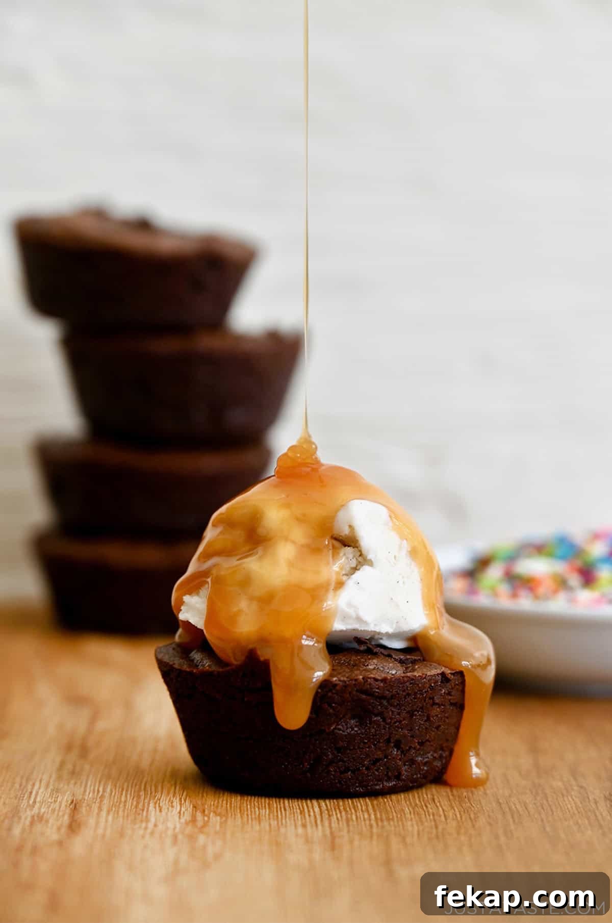 Fudgy Chocolate Brownies Recipe 14 A fudgy brownie cupcake topped with vanilla bean ice cream and a thick drizzle of caramel sauce.