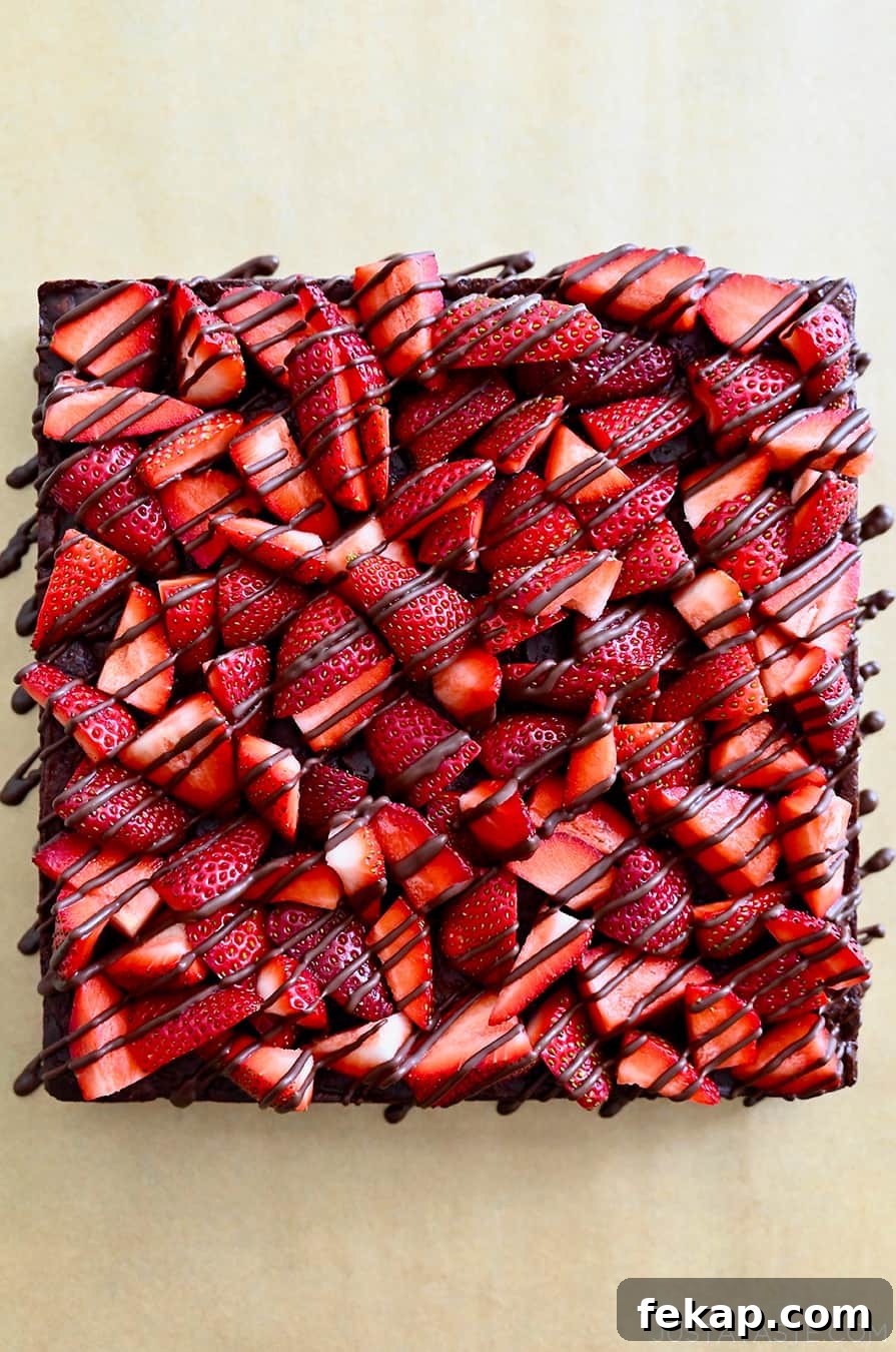 Fudgy Chocolate Brownies Recipe 23 A top-down view of Chocolate-Covered Strawberry Brownies drizzled with chocolate