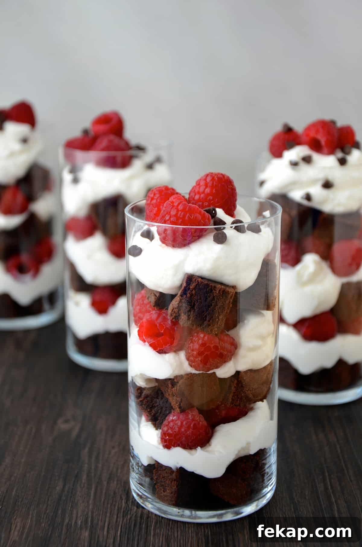 Fudgy Chocolate Brownies Recipe 4 Several parfait glasses filled with layers of brownie pieces, whipped cream and fresh raspberries.