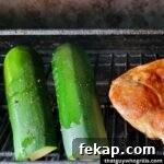 Grilled Zucchini cooking on grill rack with pork steak