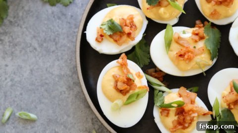 deviled eggs on a plate with herbs