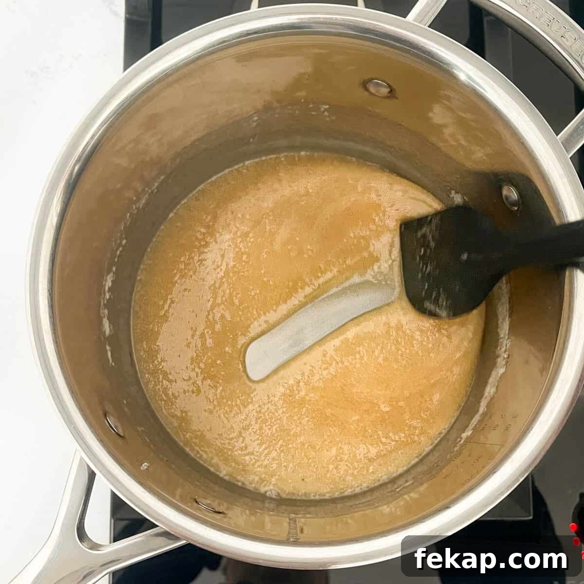 Peanut Brittle Without Corn Syrup 7 Testing the consistency of the caramel by drawing a line through it and leaving a clear trail on the bottom of the saucepan.