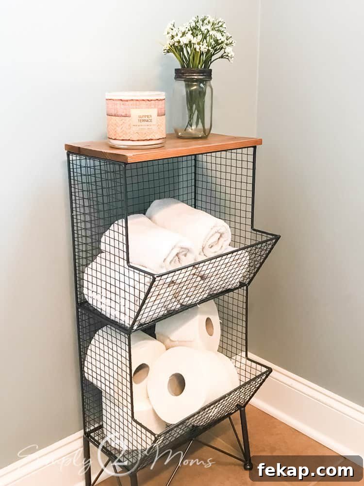wire storage tower with wood top filled with rolled towels and toliet paper