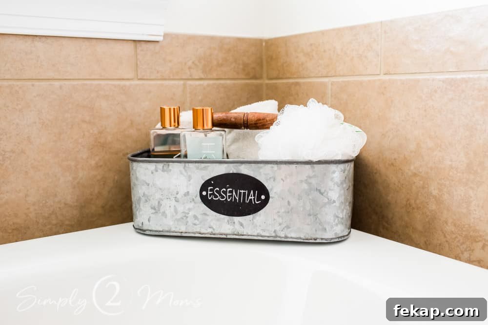 galvanized bin sitting in corner of tub with loofah and bottles of body wash inside