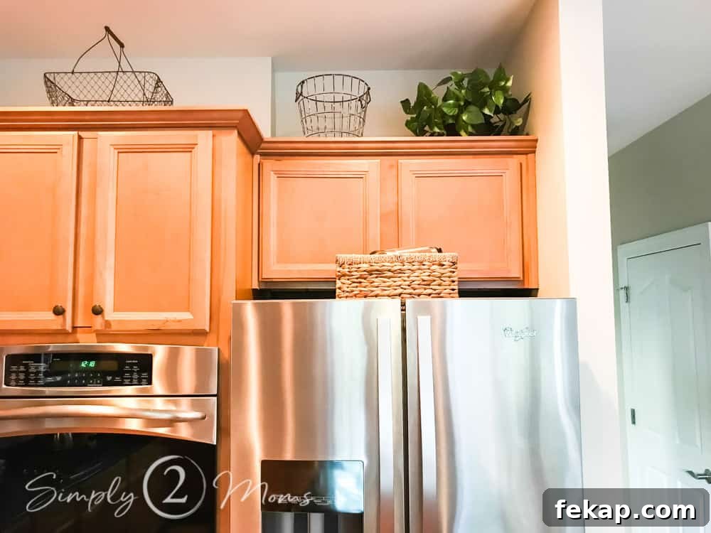 image of basket on top of fridge with cabinets and baskets displayed above