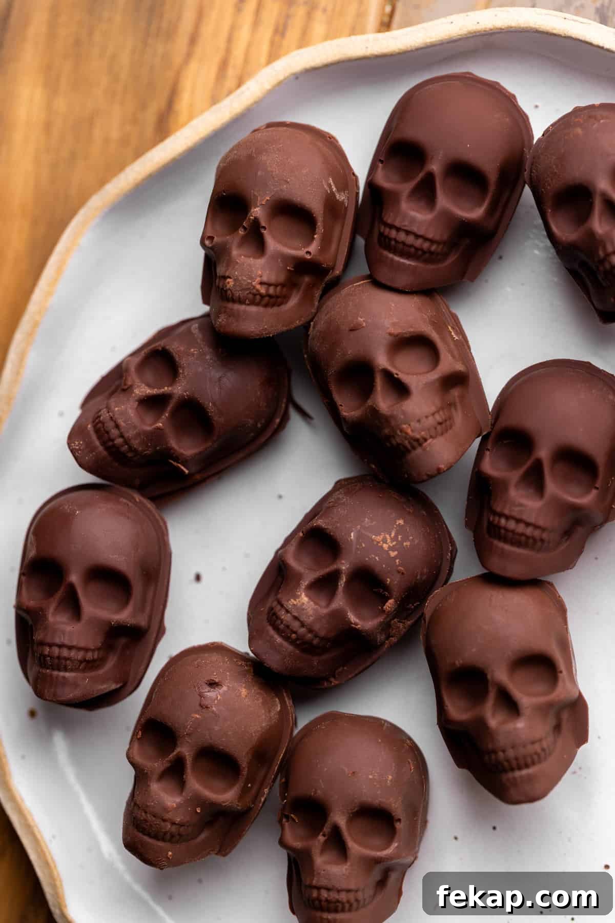 Spooky Halloween Chocolate Cake Recipe 8 Chocolate skulls on a plate.