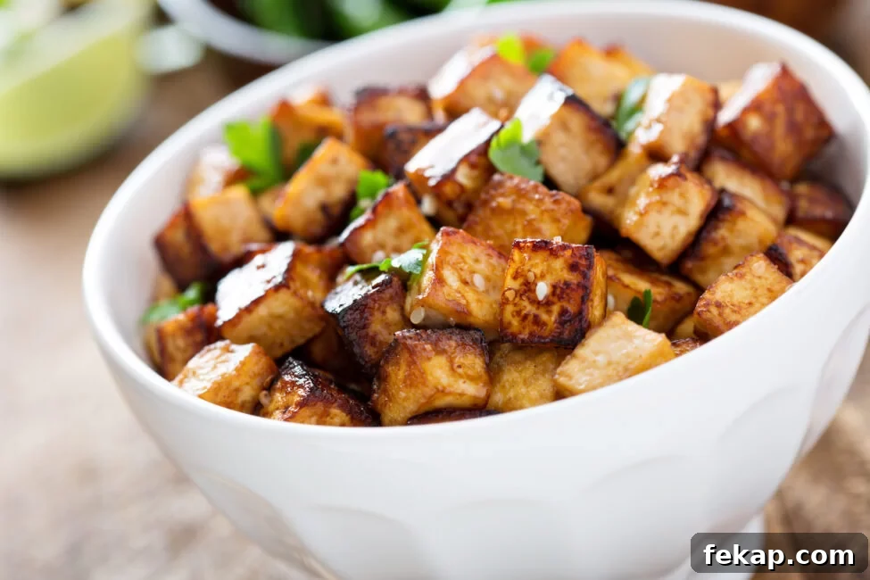 4 Ways to Cook Tofu for Crispy, Flavorful Results 2 Stir fried tofu in a bowl with sesame and greens