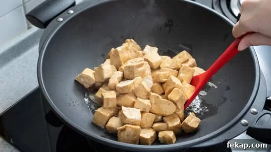 4 Ways to Cook Tofu for Crispy, Flavorful Results 4 Cooking diced cubed dried tofu on gas stove.