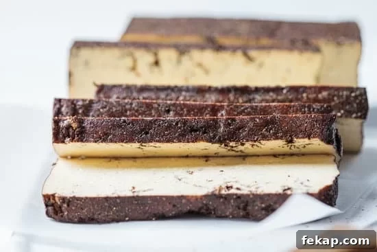 4 Ways to Cook Tofu for Crispy, Flavorful Results 6 Sliced Smoked Tofu on paper and white background