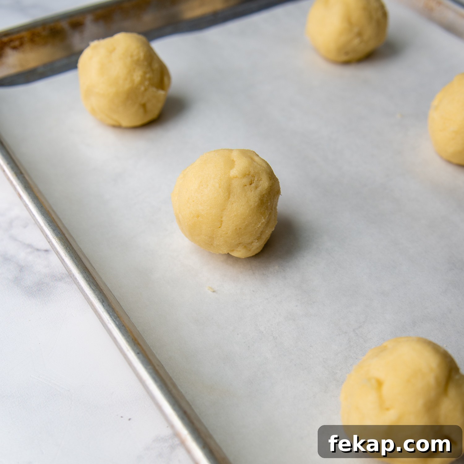large balls shaped on a cookie sheet.