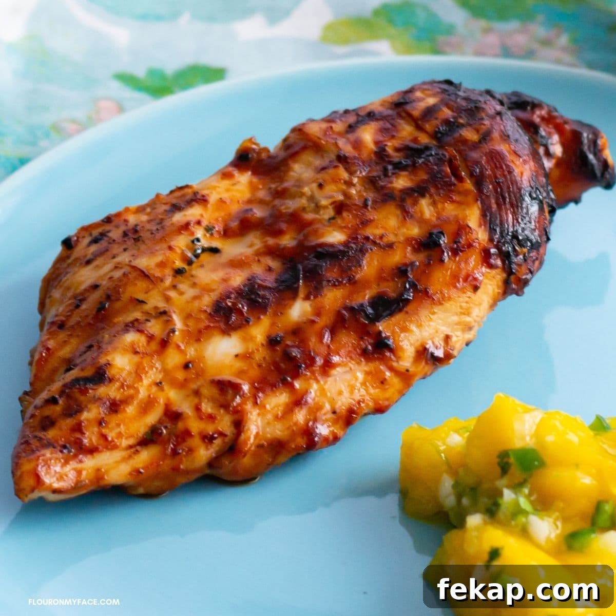 Cilantro-Pineapple Grilled Chicken Recipe 2 Pineapple Grilled Chicken breast on a dinner plate with mango salsa.