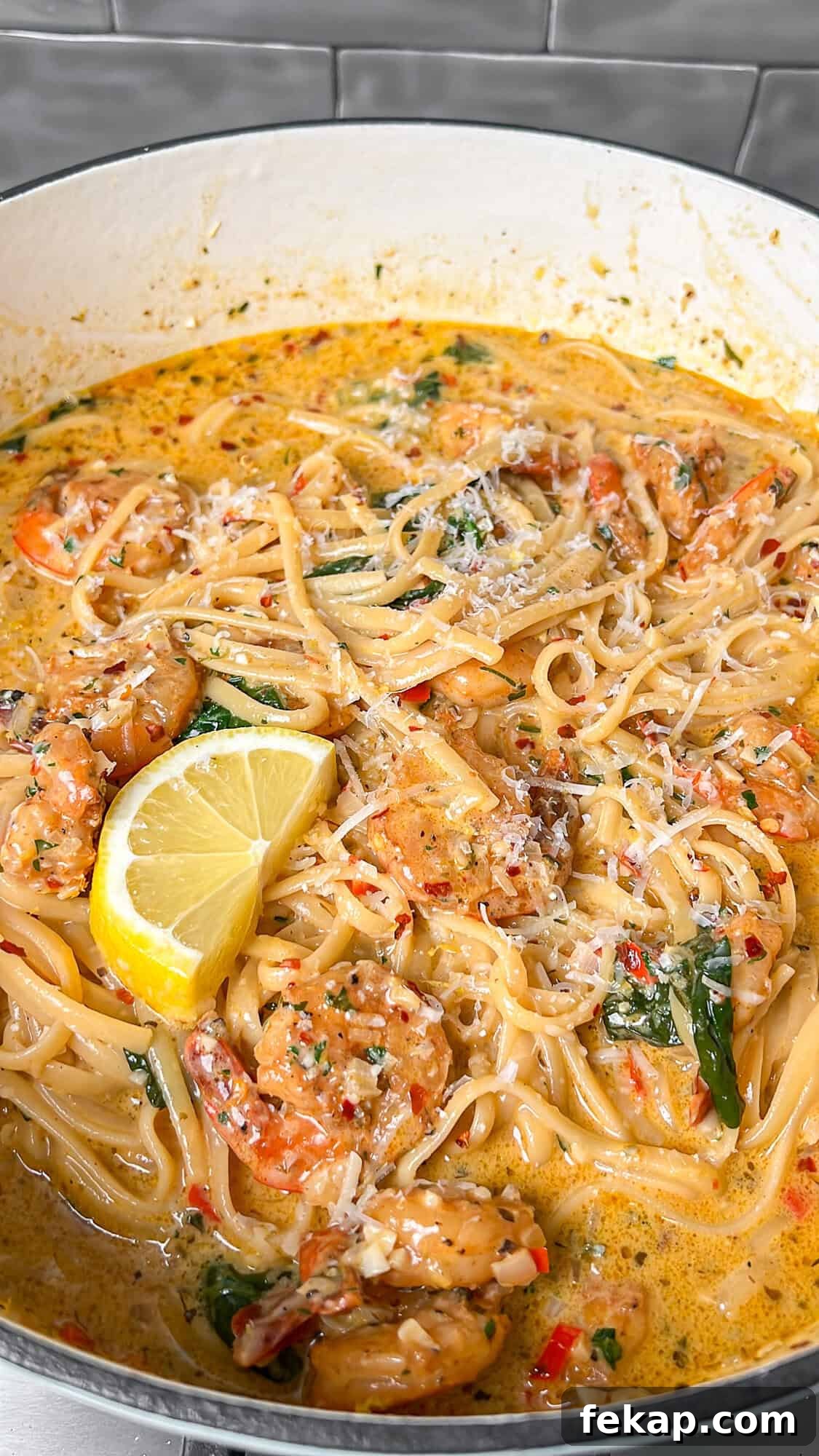One-Pot Garlic Butter Shrimp Scampi with Lemon 8 cooked shrimp scampi in a pot with lemon wedges