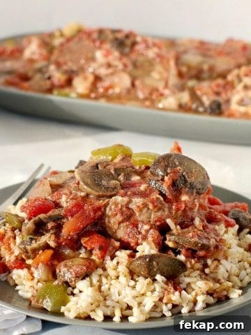 Slow Cooker Swiss Steak on Rice (on green plate)