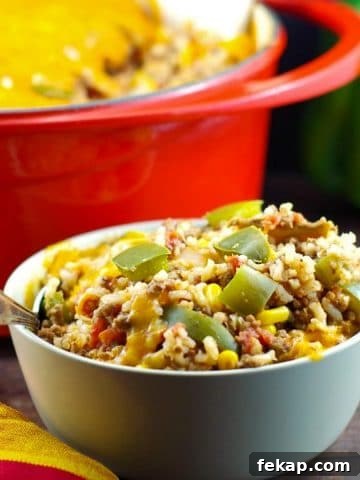 bowl of ww stuffed green pepper casserole in front of a orange casserole dish in background