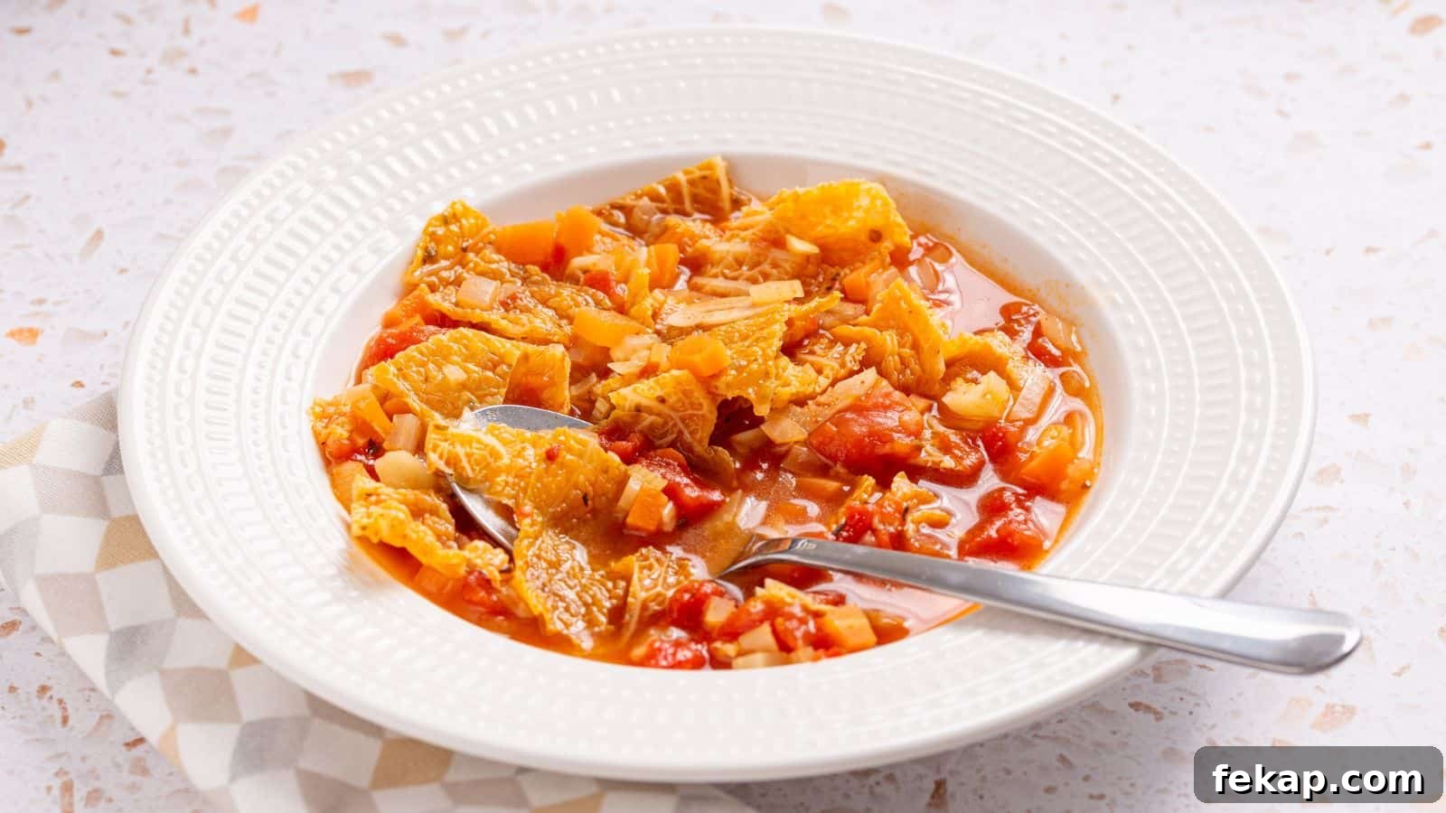 15 Soups and Stews That Make You Forget It's Summer 8 A bowl of hearty tomato-based soup with cabbage.