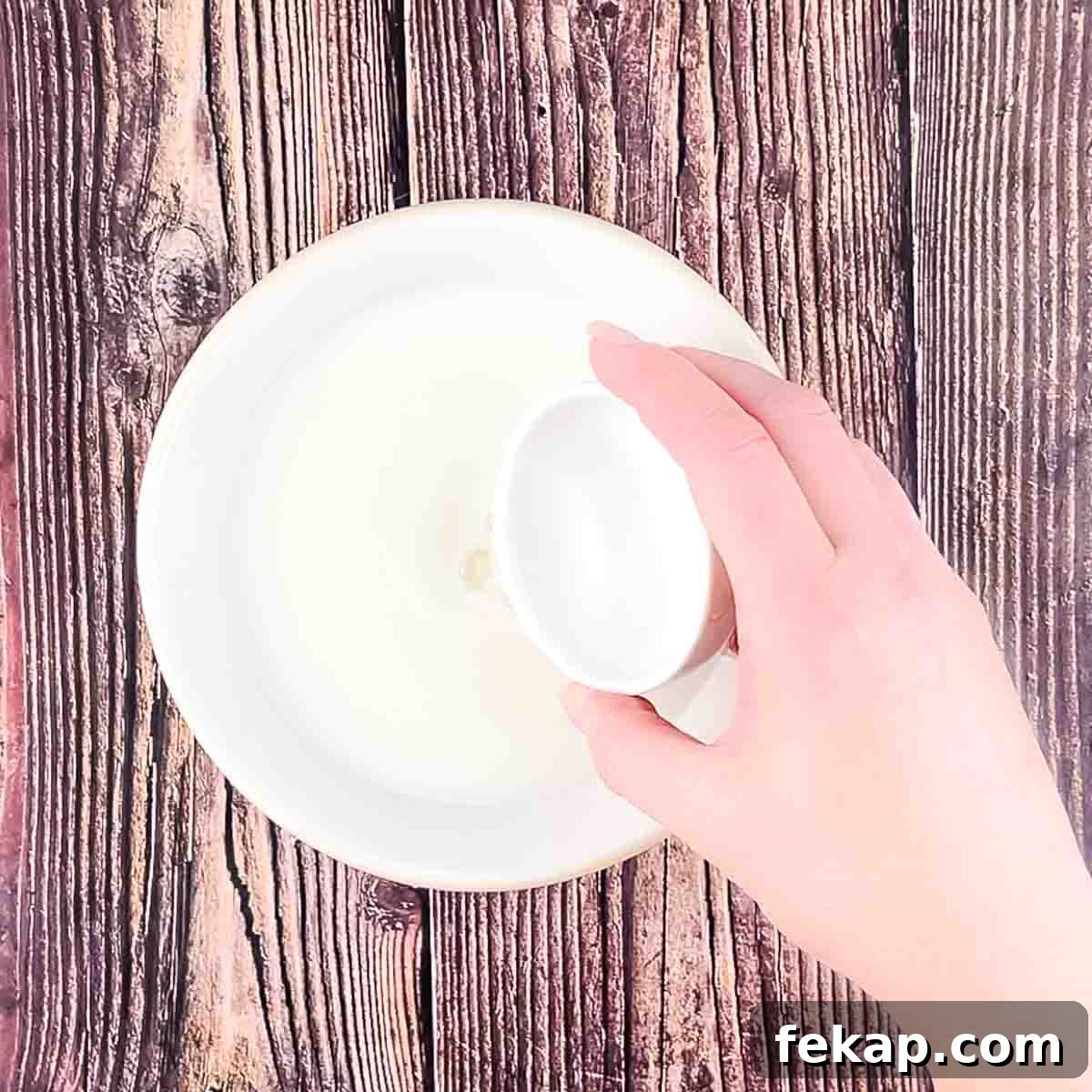 How to Make Irish Soda Bread Without Buttermilk 4 White vinegar being poured into a small bowl of milk.