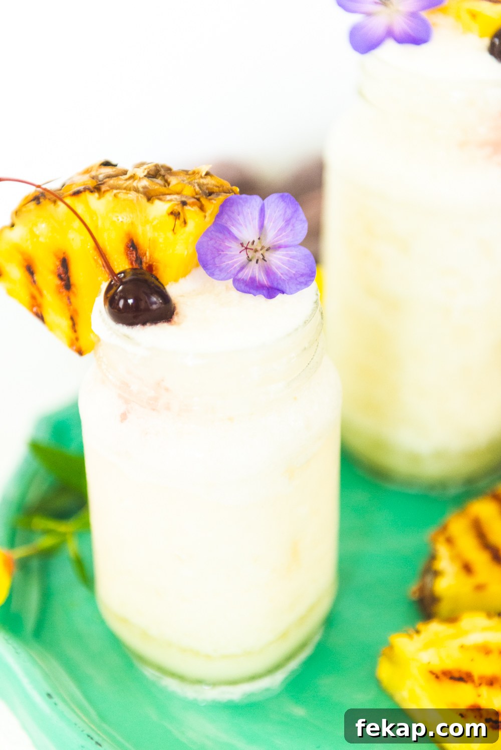 How to Make a Classic Frozen Piña Colada 3 Up close shot of pina colada in a mason jar.