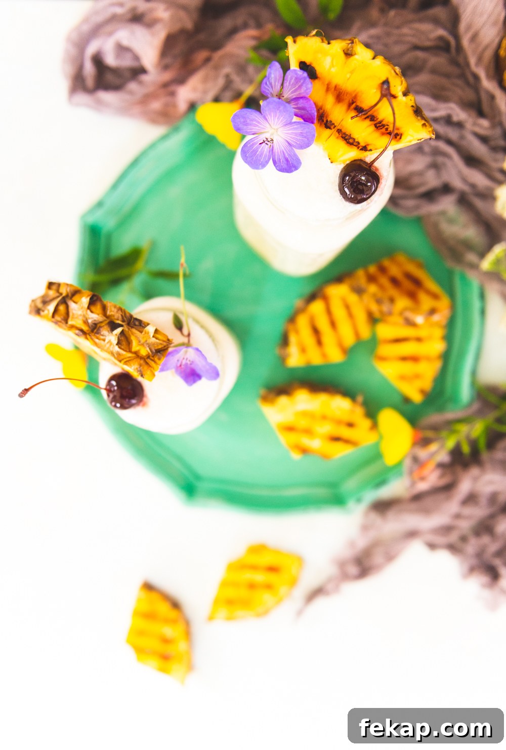 How to Make a Classic Frozen Piña Colada 5 Soft focus on grilled pineapple garnish.