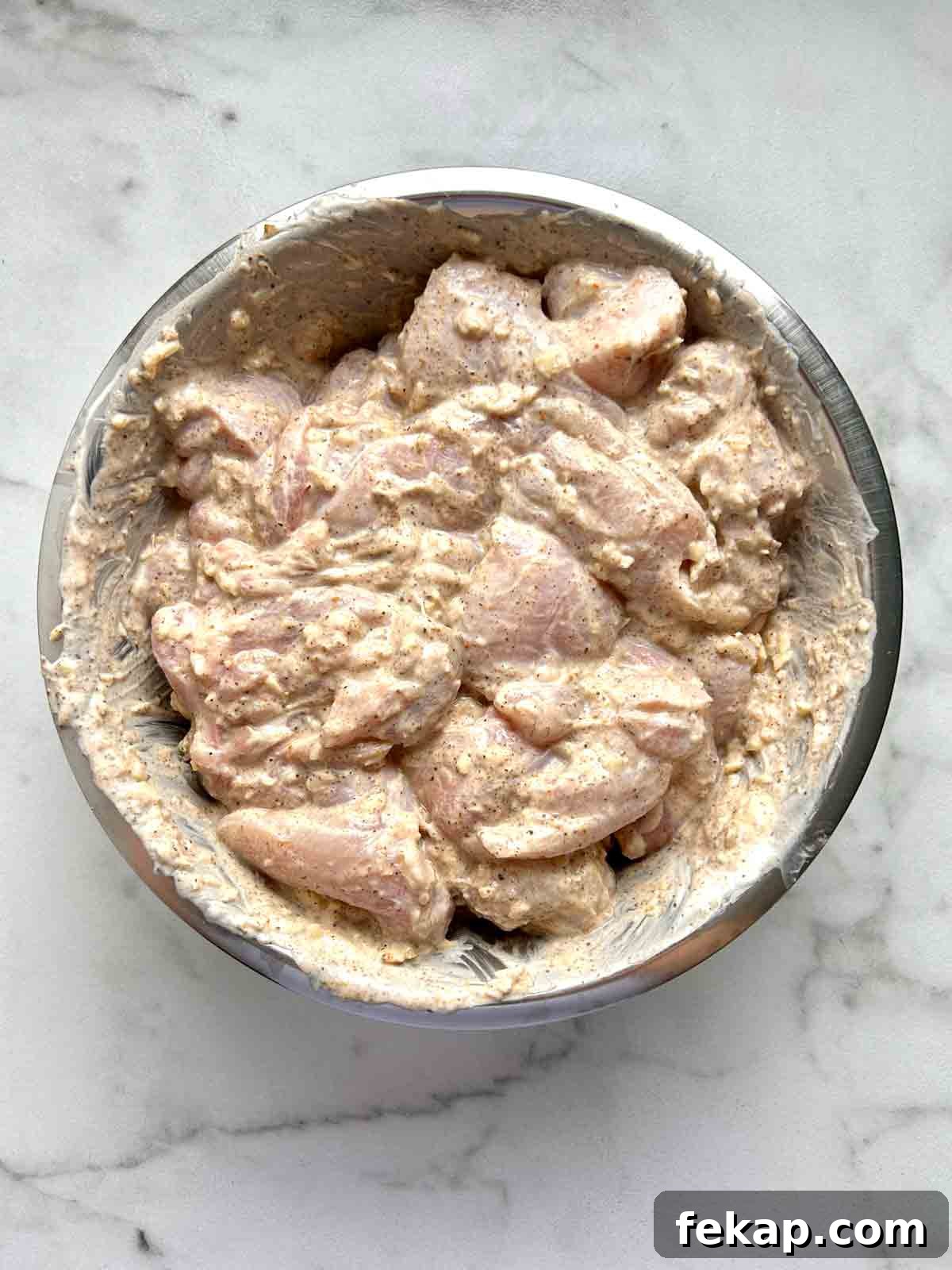 Creamy Butter Chicken Recipe: Authentic Indian Flavor 4 chicken being marinated in bowl.