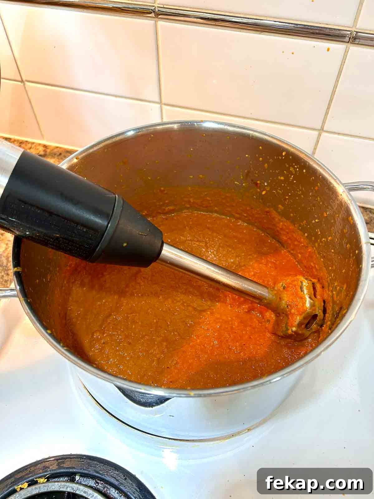 Creamy Butter Chicken Recipe: Authentic Indian Flavor 7 sauce being pureed in pot.