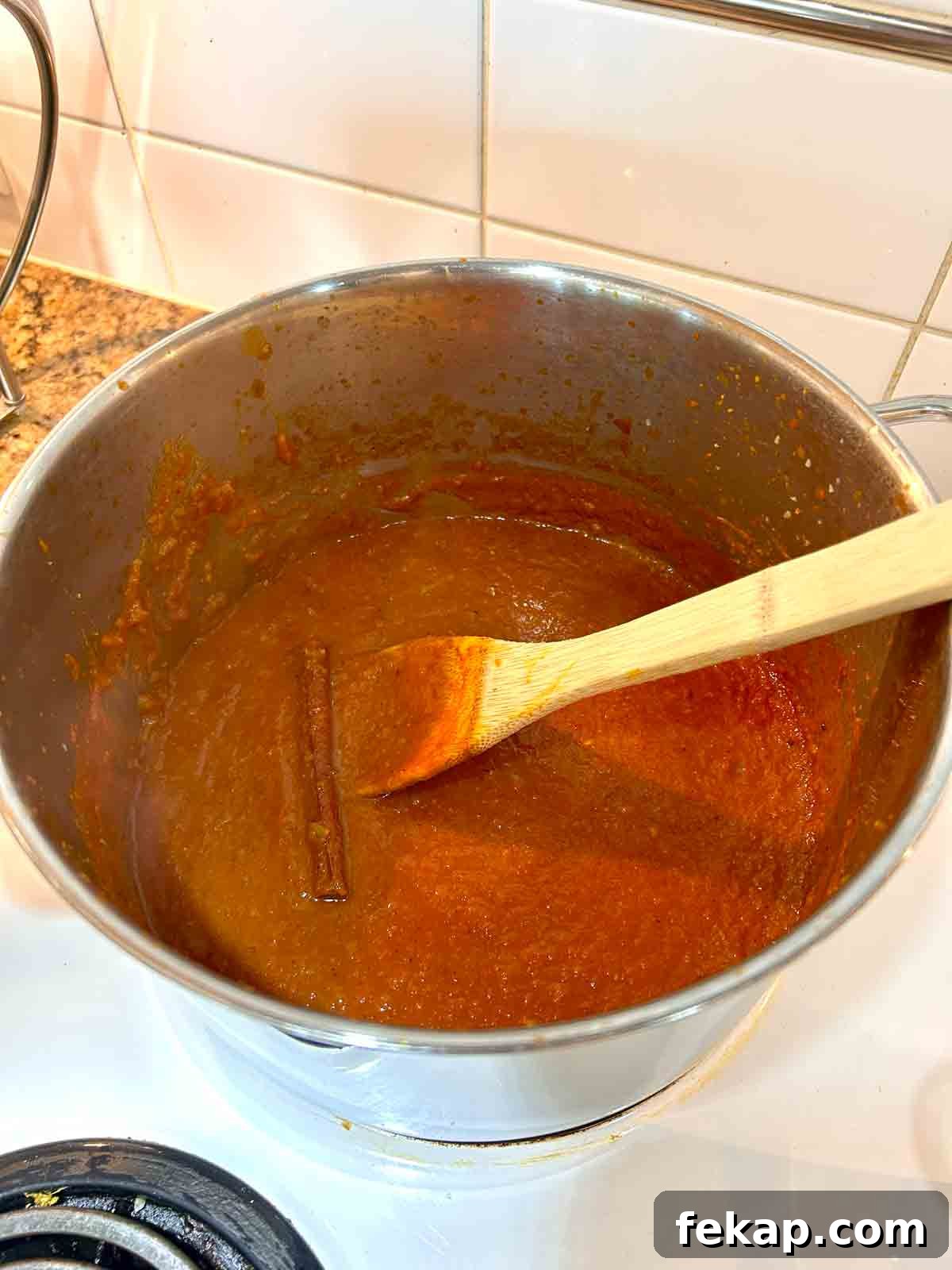 Creamy Butter Chicken Recipe: Authentic Indian Flavor 8 butter chicken sauce simmering with cinnamon stick.