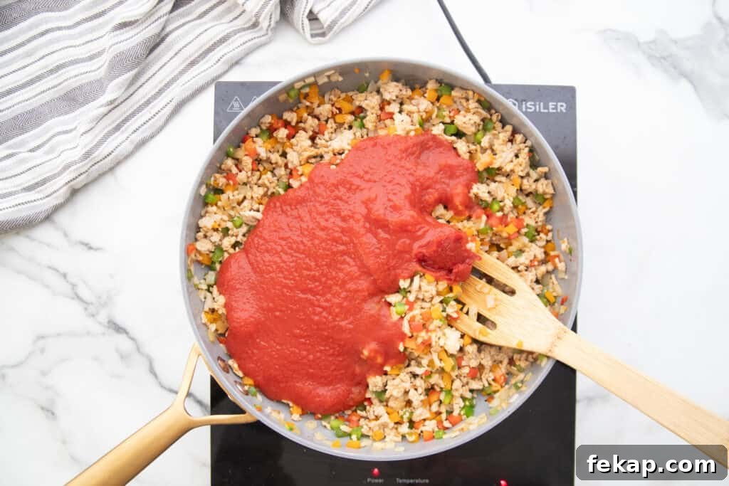 One Pan Stuffed Pepper Skillet Recipe 6 Stuffed pepper skillet mixture with tomato sauce added on top.