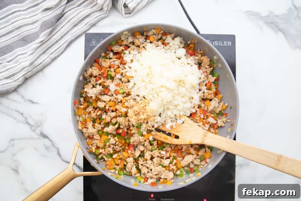 One Pan Stuffed Pepper Skillet Recipe 7 Skillet with ground chicken, bell peppers, and cauliflower rice.