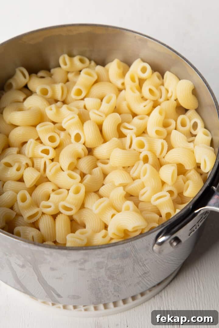 Creamy Old Fashioned Mac and Cheese Recipe 5 cooked macaroni pasta in a saucepan.