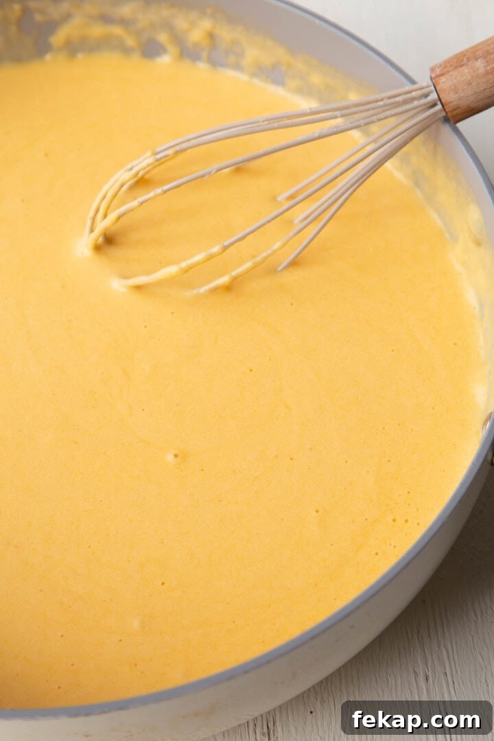 Creamy Old Fashioned Mac and Cheese Recipe 8 cheesy, creamy sauce in a skillet with a whisk.