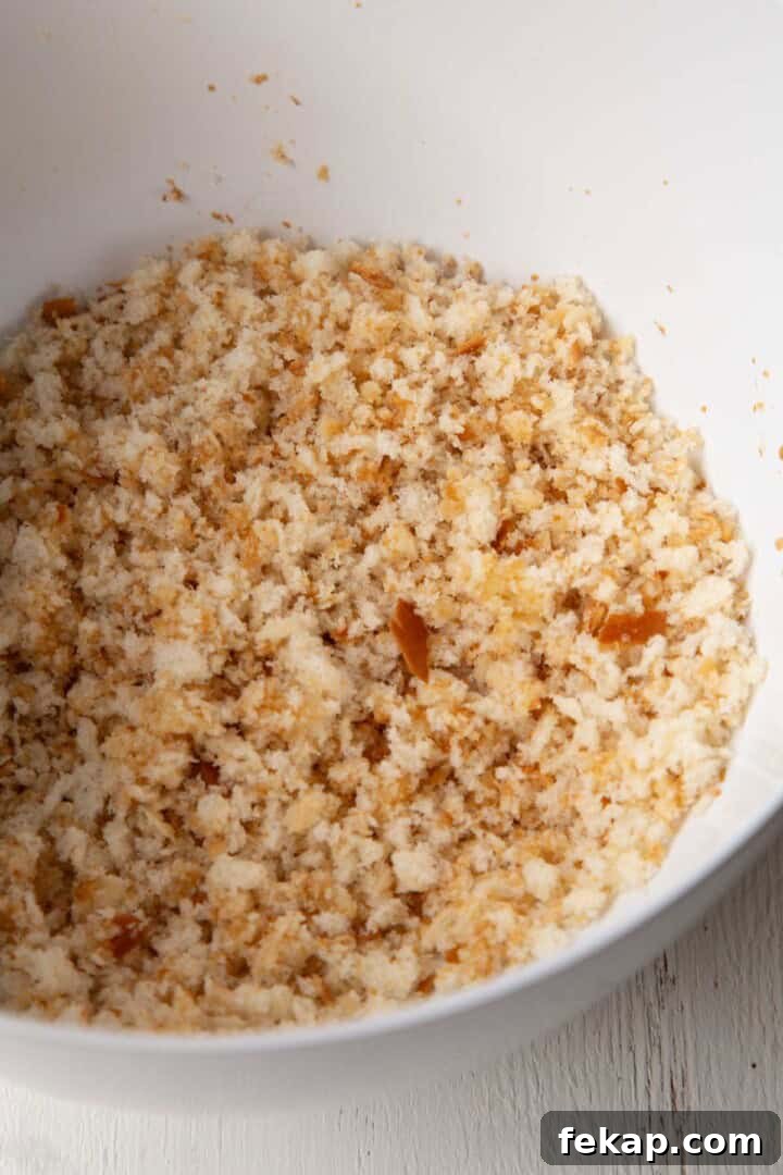 Creamy Old Fashioned Mac and Cheese Recipe 9 breadcrumbs tossed with butter in a bowl.