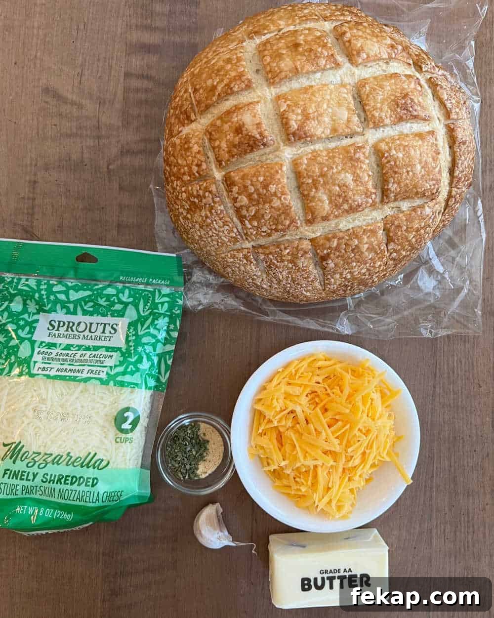 Garlic Herb Cheesy Pull-Apart Bread Recipe 3 boule bread loaf, cheddar, mozzarella, garlic, butter and seasonings.