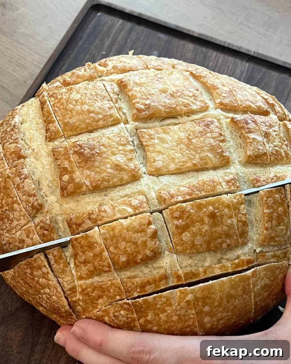 Garlic Herb Cheesy Pull-Apart Bread Recipe 4 slice bread loaf with knife.