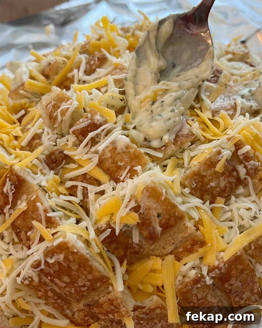 Garlic Herb Cheesy Pull-Apart Bread Recipe 6 sliced boule bread stuffed with cheese.