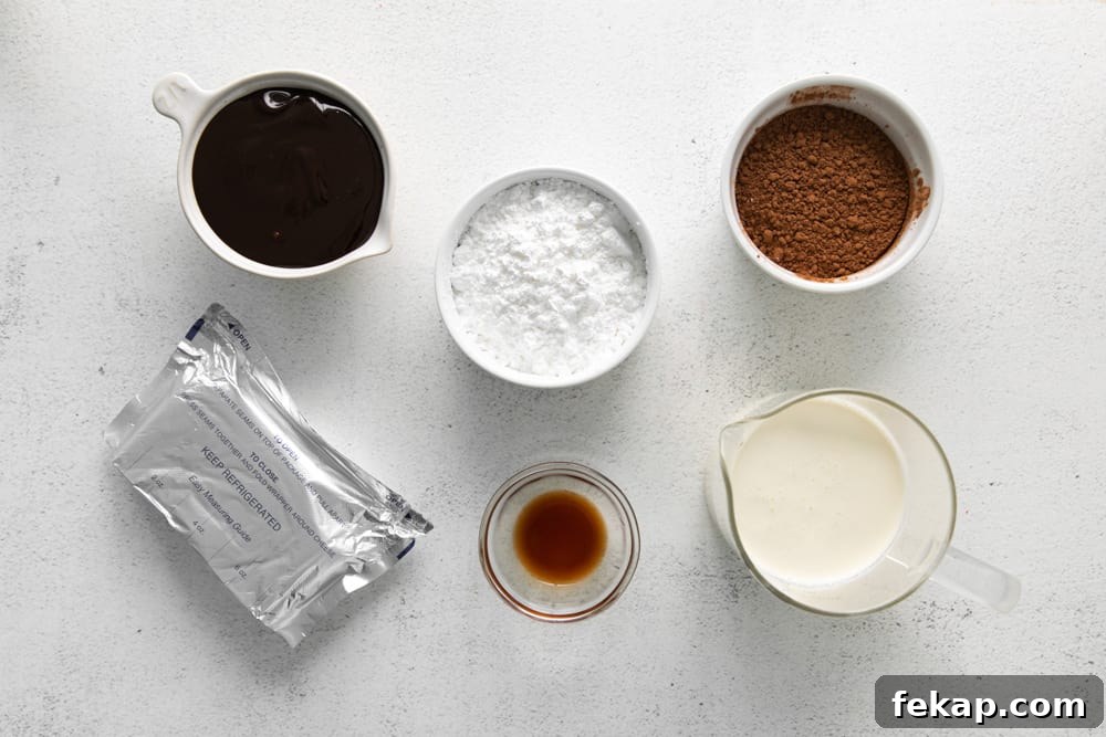How to Make Chocolate Cheesecake Mousse Cups 10 overhead view of ingredients for no bake chocolate cheesecake cups in individual bowls.