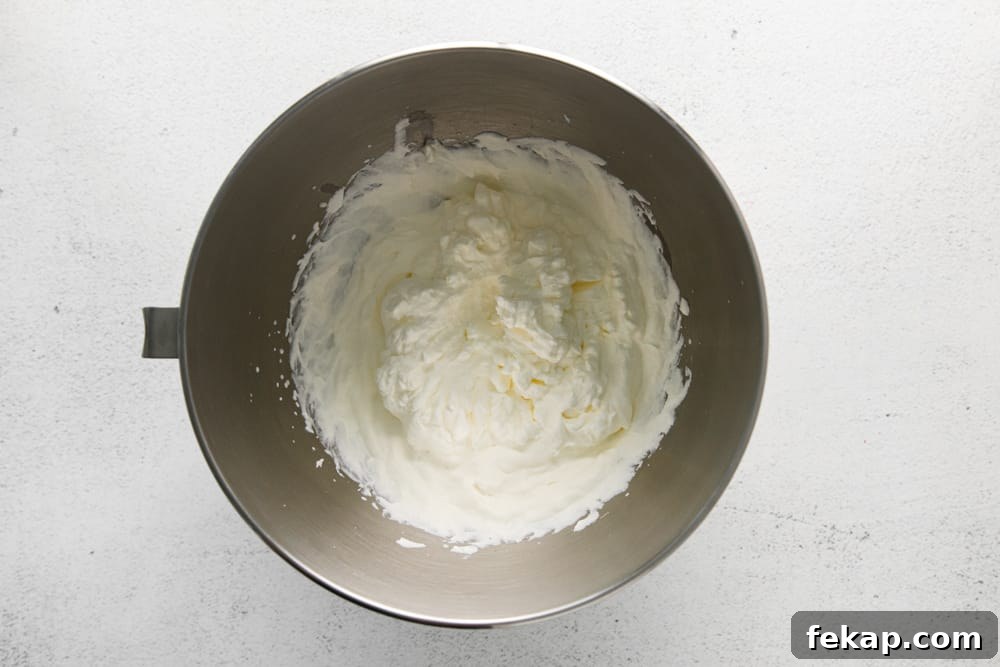 How to Make Chocolate Cheesecake Mousse Cups 11 beaten whipped cream in a stainless mixing bowl.
